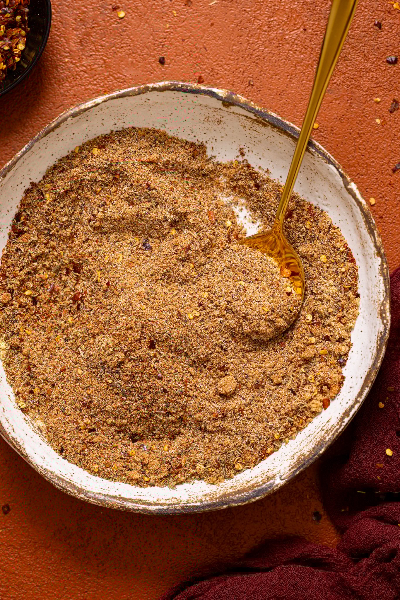 ‘On Everything’ BBQ Dry Rub Seasoning in a bowl with a spoon.