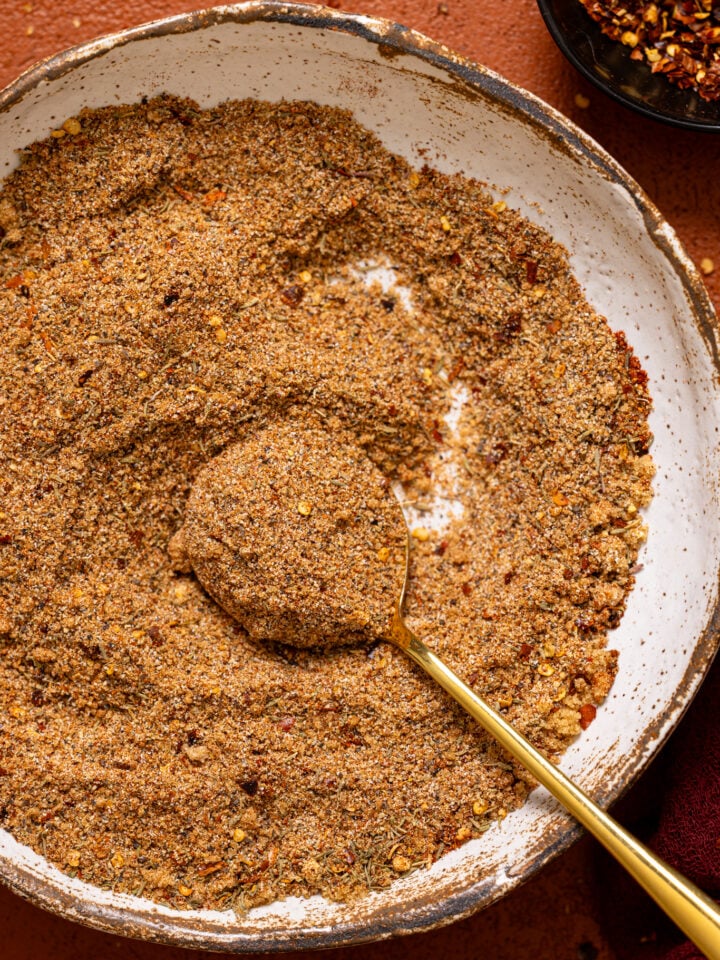 Up close shot of ‘On Everything’ BBQ Dry Rub Seasoning in a bowl with a spoon.