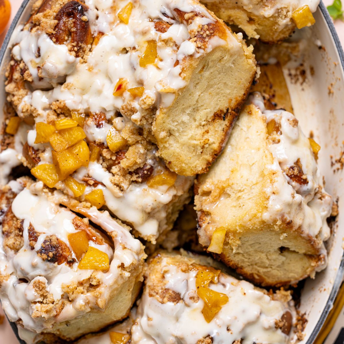 Up close shot of Southern Peach Cobbler Cinnamon Rolls in a baking dish.