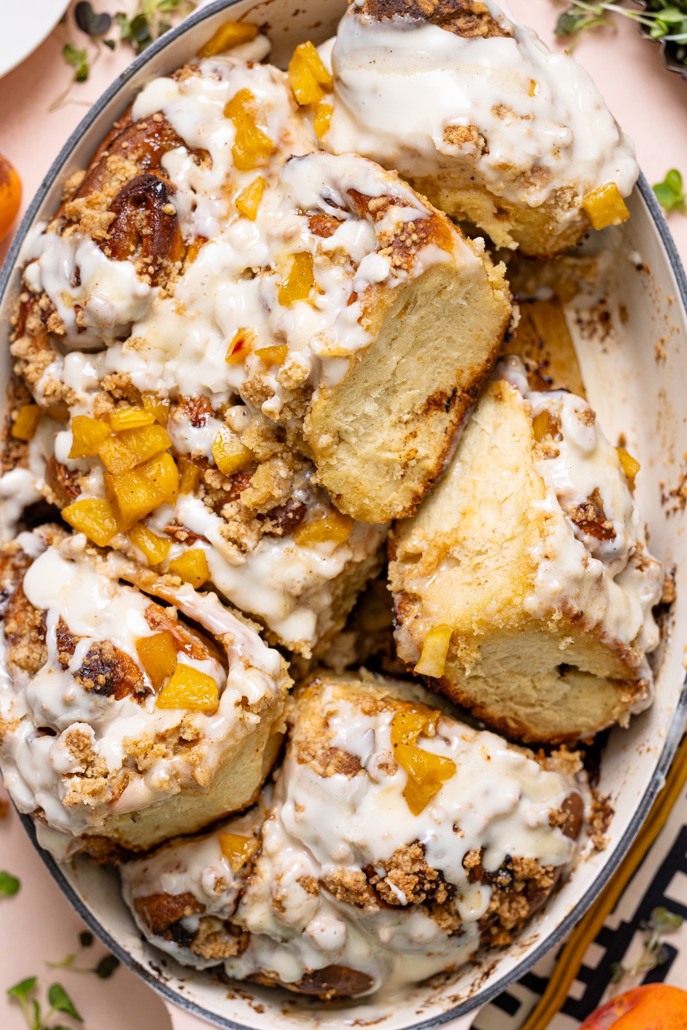 Up close shot of Southern Peach Cobbler Cinnamon Rolls in a baking dish.