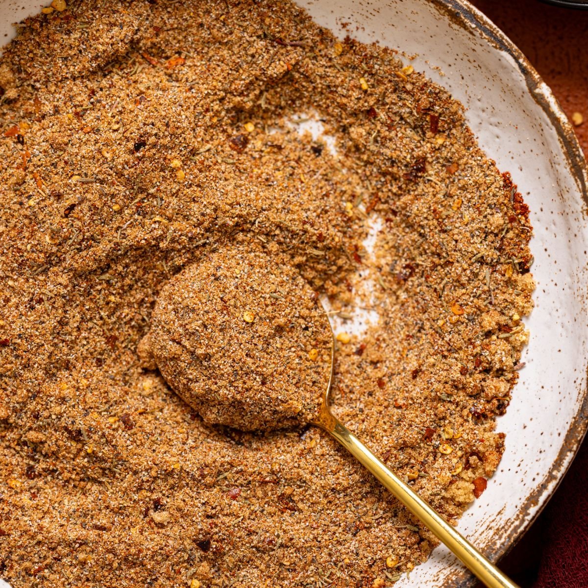 Up close shot of ‘On Everything’ BBQ Dry Rub Seasoning in a bowl with a spoon.