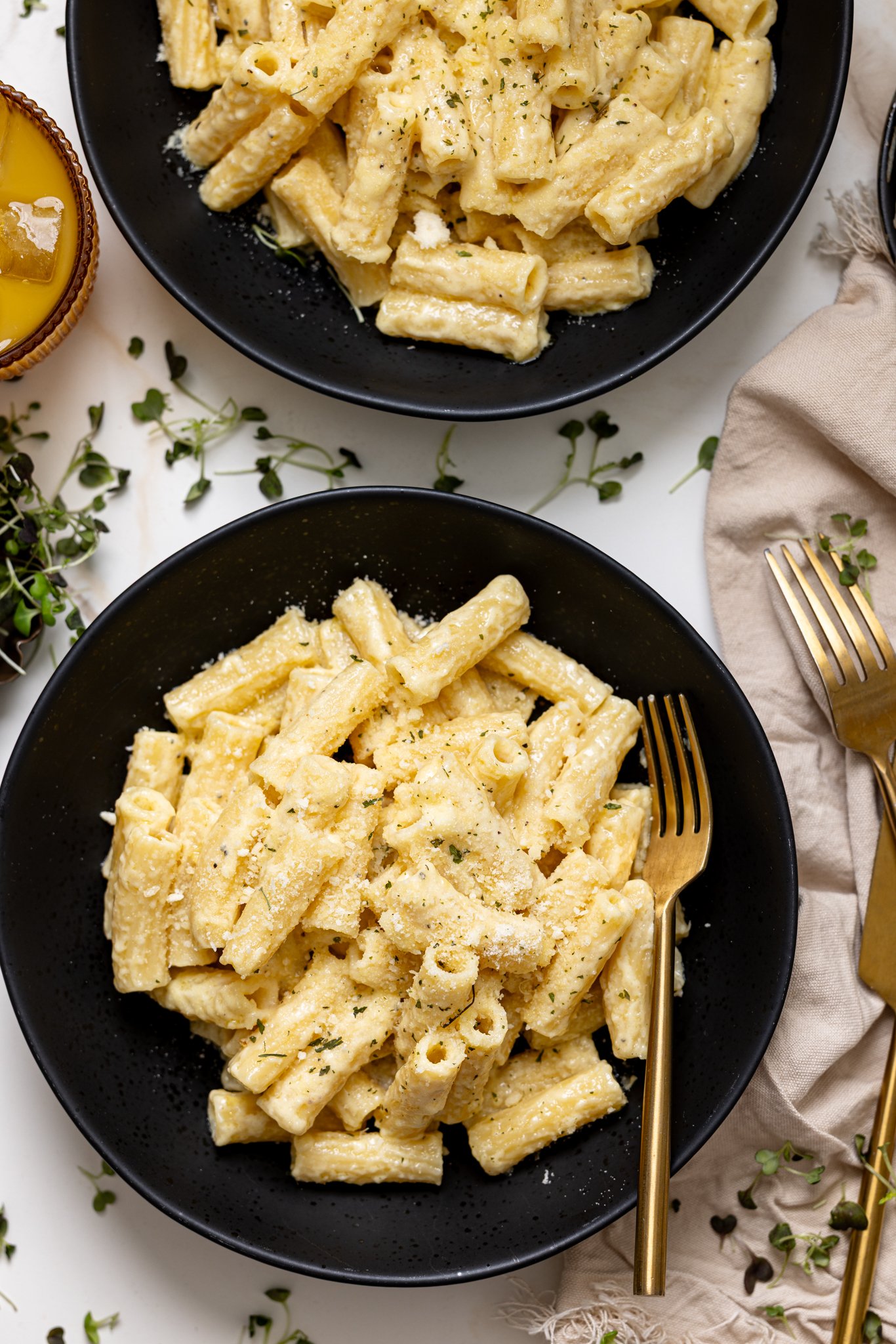 Creamy Weeknight Alfredo Pasta in a bowl with utensils.