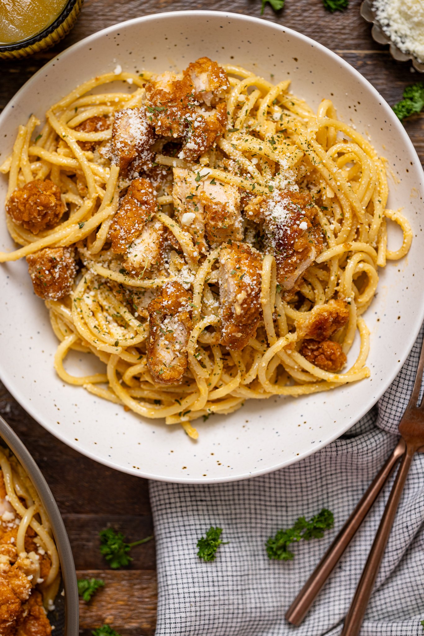 Southern Creamy Parmesan Garlic Chicken Pasta on a plate with forks on the side.