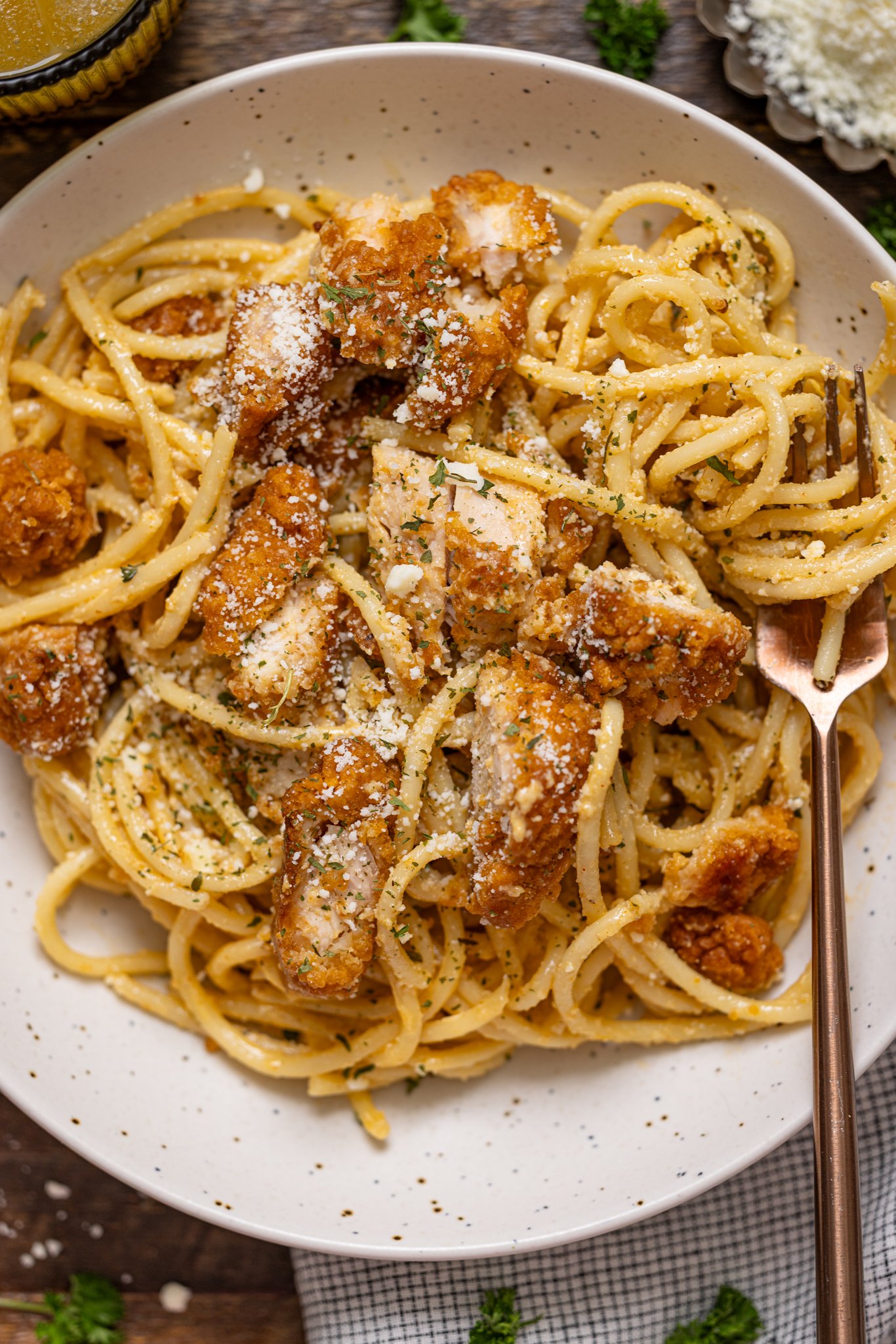 Up close shot of Southern Creamy Parmesan Garlic Chicken Pasta on a plate with a fork.