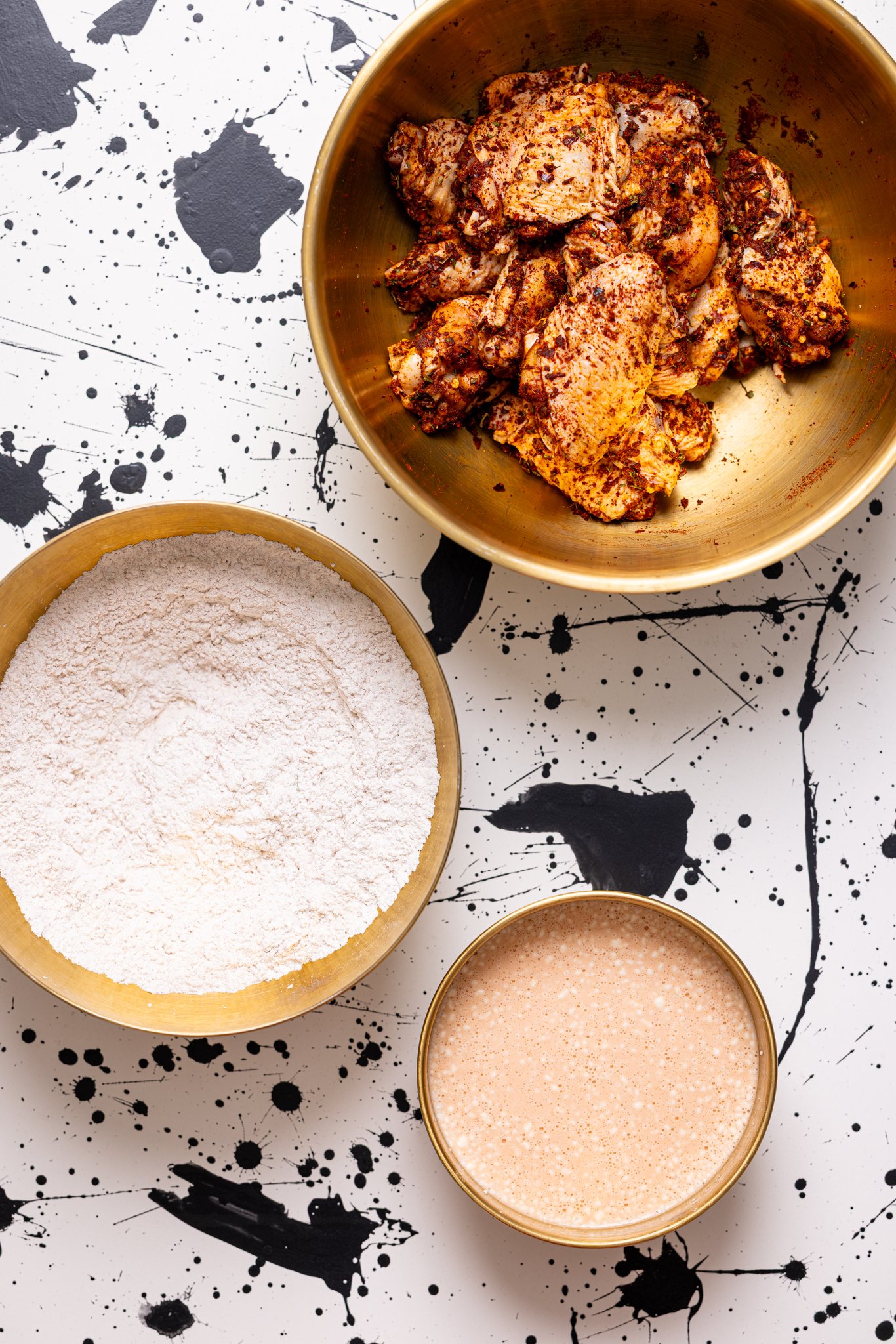 Seasoned chicken wings with dry and wet ingredients.