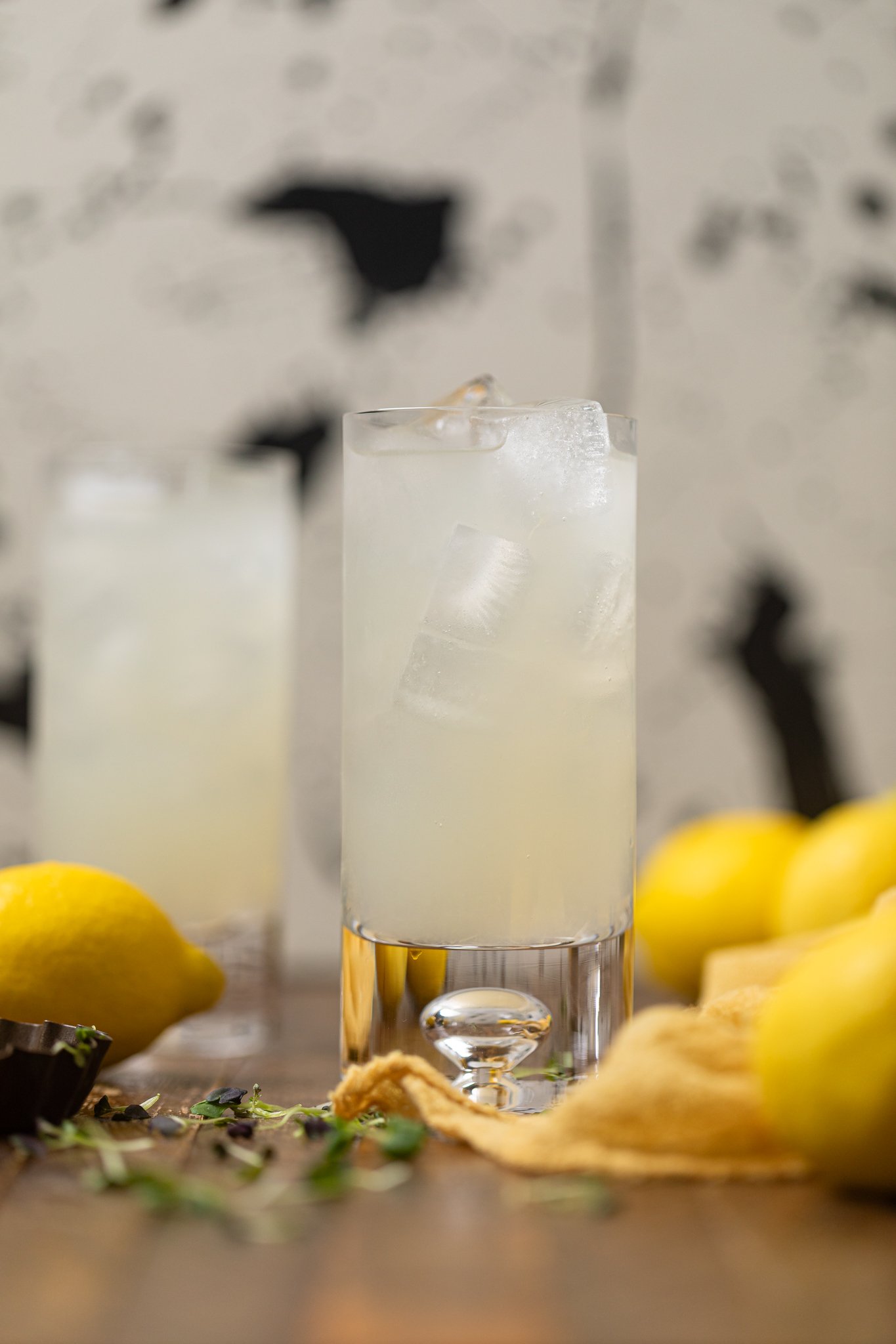 Refreshing Homemade Lemonade in two glasses with lemons.