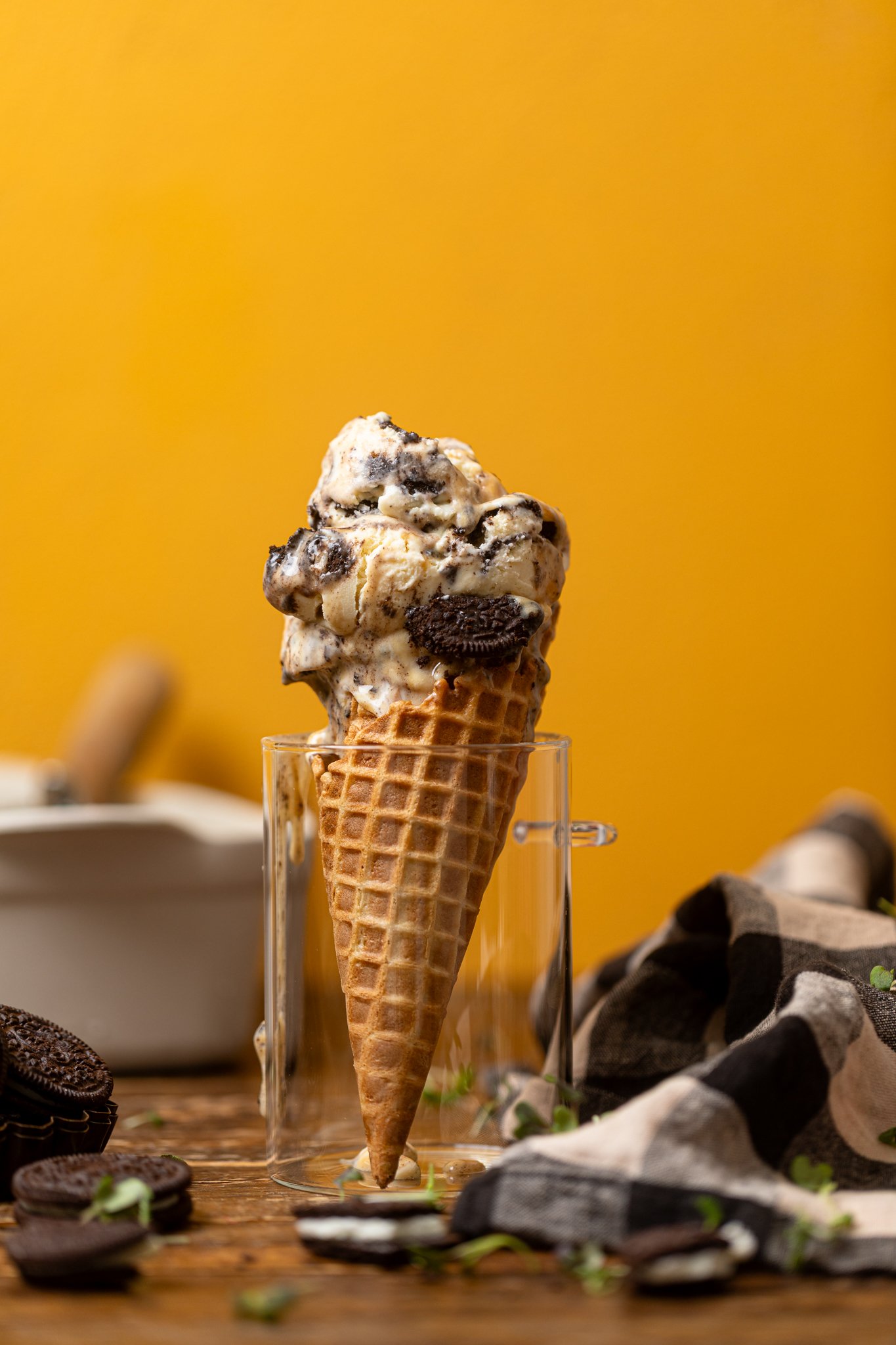 No-Churn Salted Caramel Oreo Ice Cream on a cone standing in a glass jar.