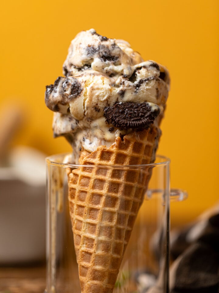 Up close shot of No-Churn Salted Caramel Oreo Ice Cream on a cone in a glass jar.