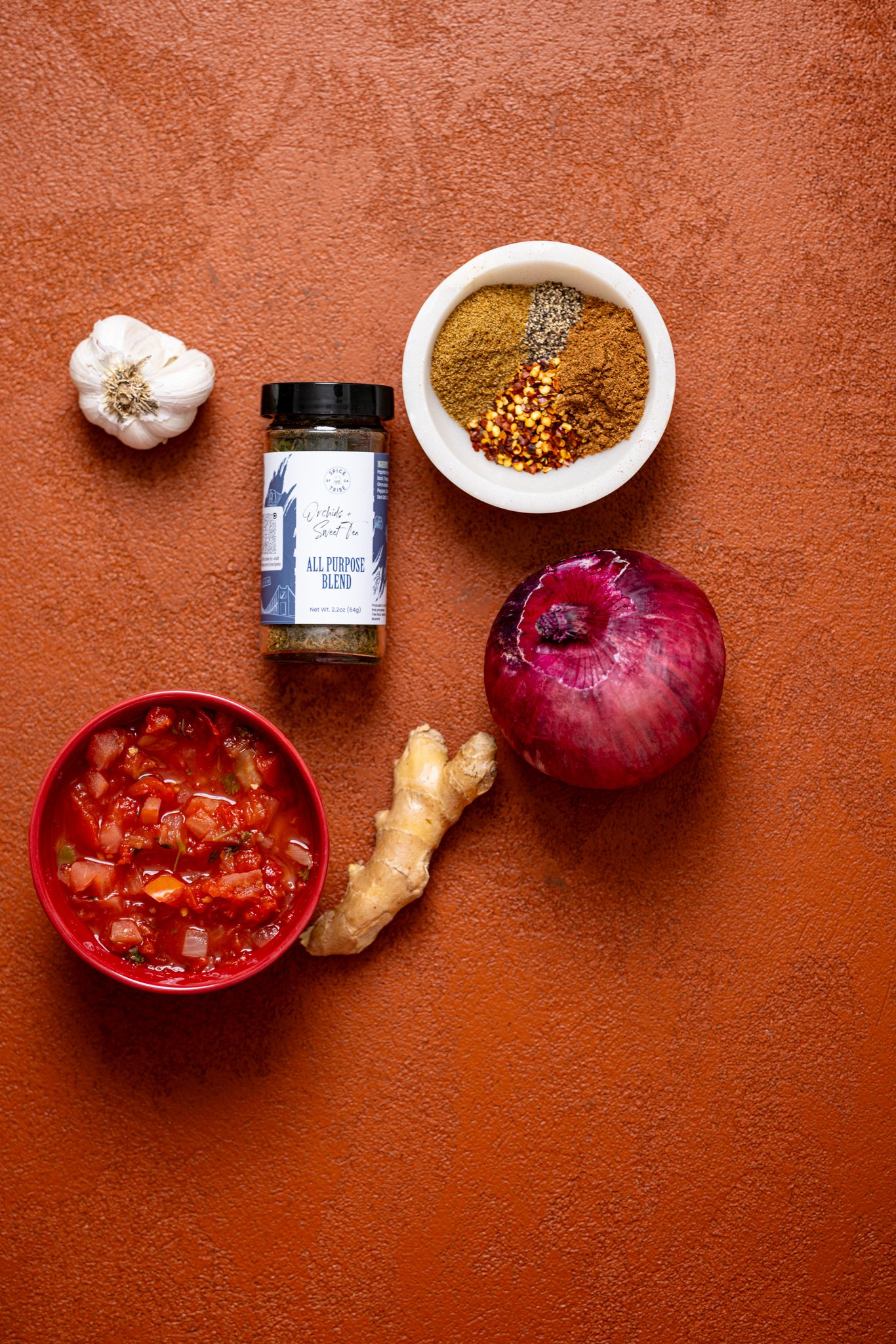 Ingredients on a burnt orange table.