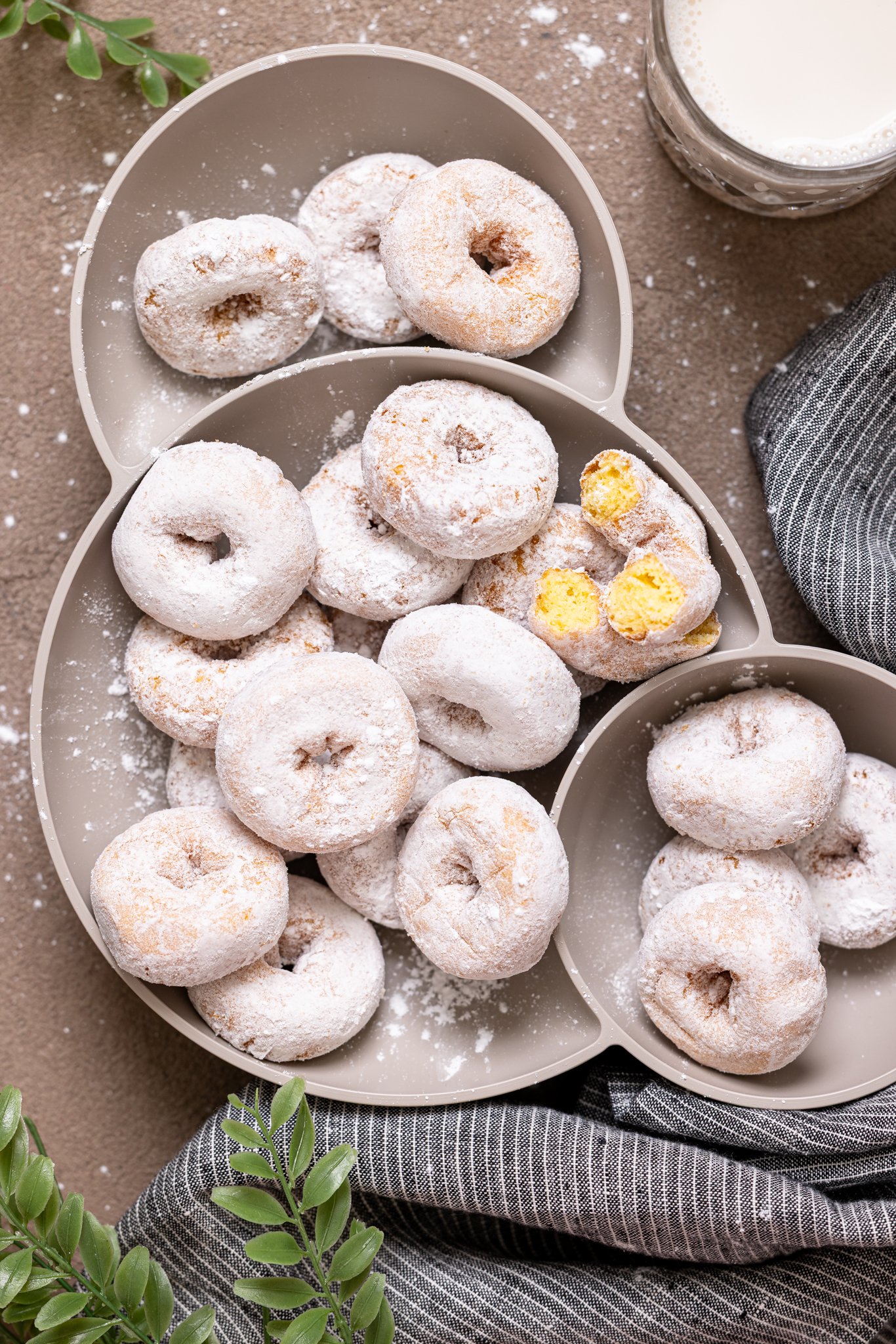 Homemade Mini Powdered Sugar Donuts in a grey 3-part platter.