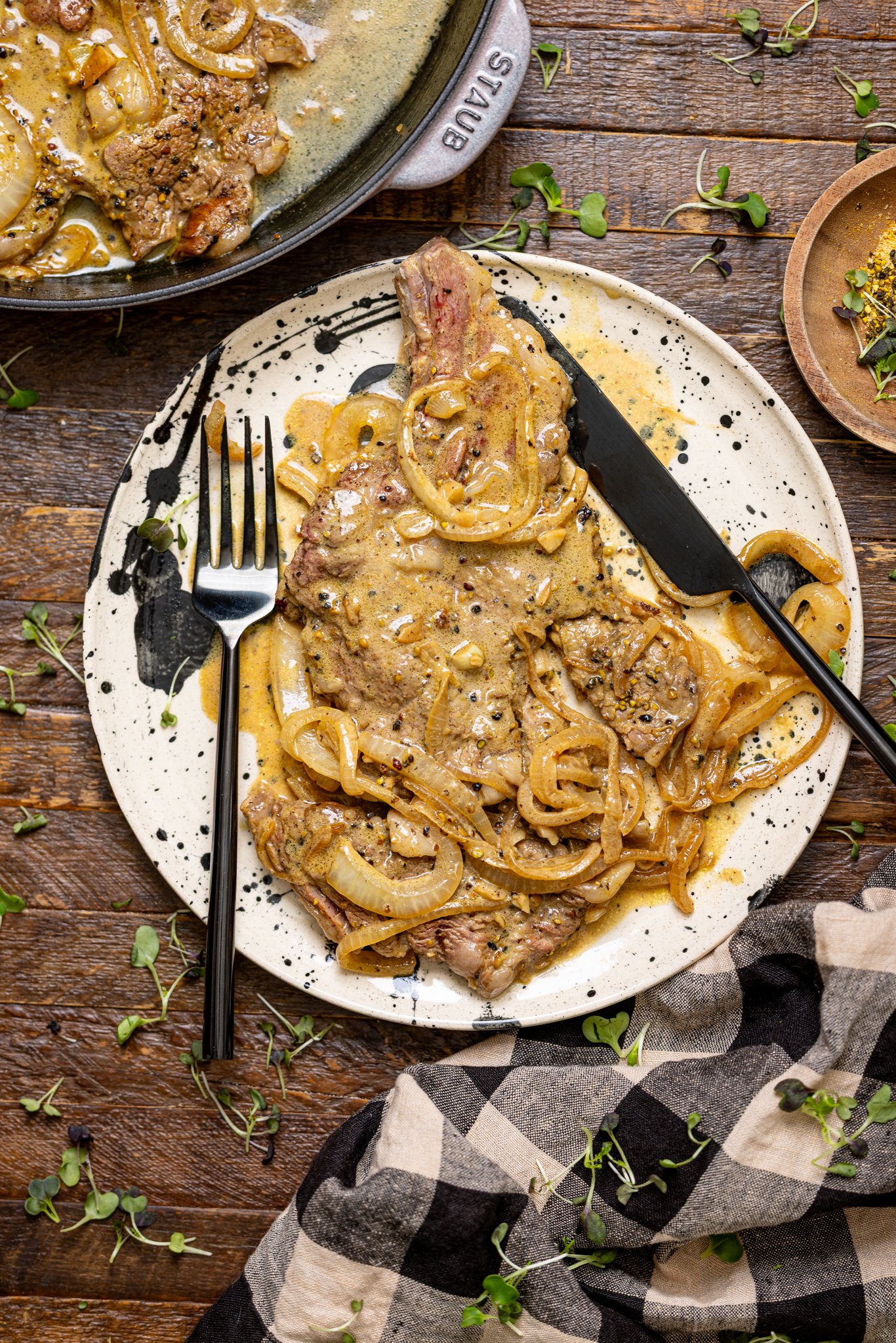 The Best Southern Smothered Steak on a plate with knife and fork.