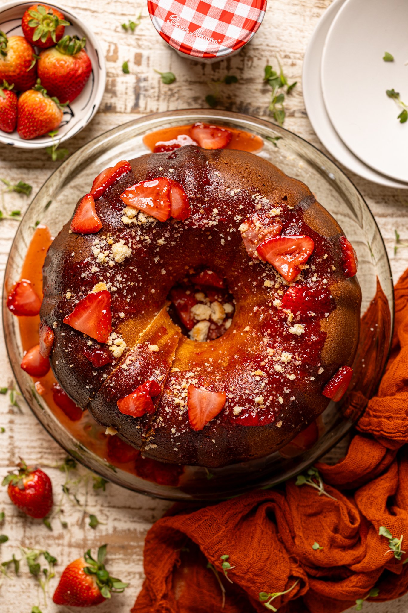 Strawberry Shortcake Bundt Cake with topping on a cake stand.