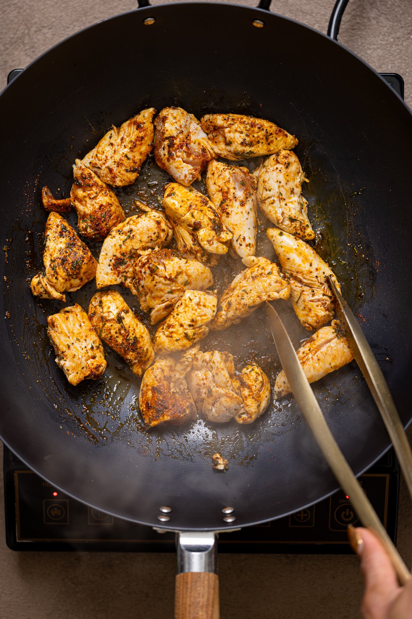 Sautéed chicken in a wok.