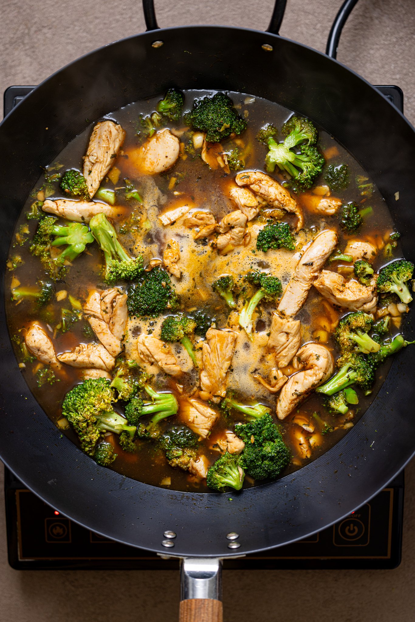 All ingredients simmering together in a wok over the stovetop.