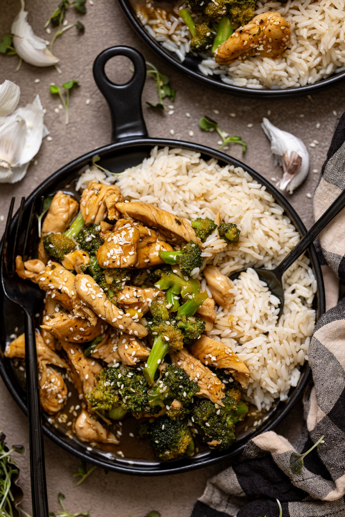 Up close shot of Take Out Honey Garlic Chicken with utensils.