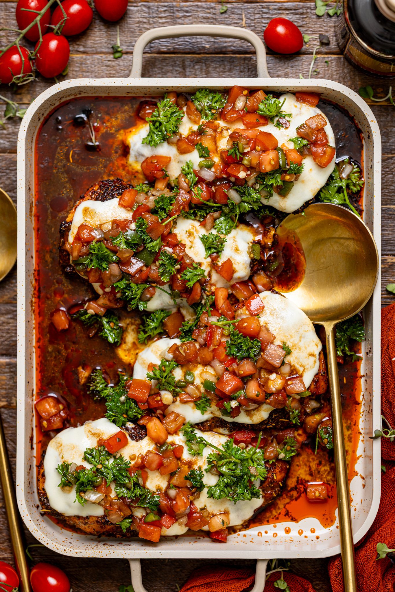 Weeknight Bruschetta Chicken Recipe on a baking griddle with a spoon.