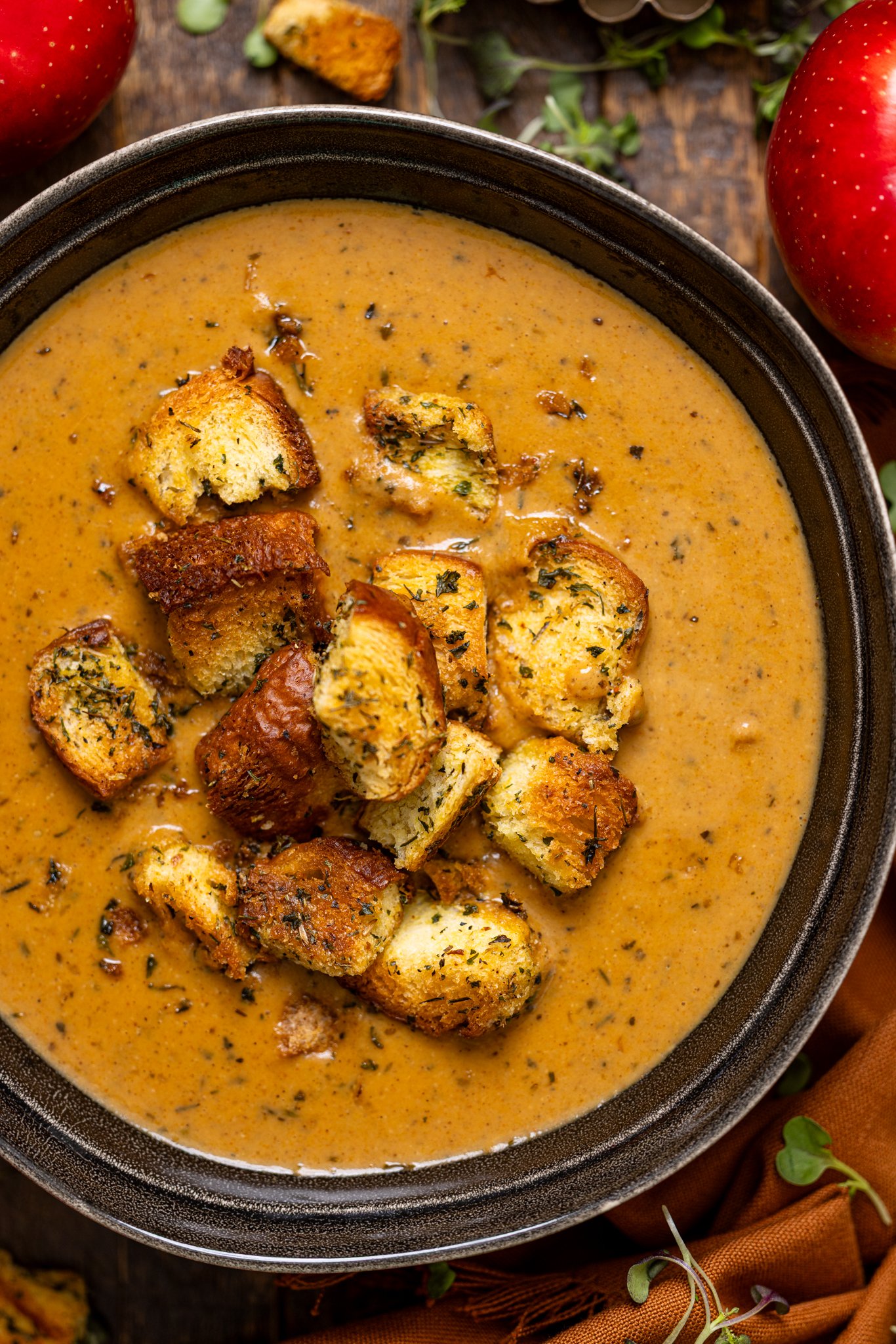 Up close shot of Creamy Roasted Apple Pumpkin Soup with croutons topping.