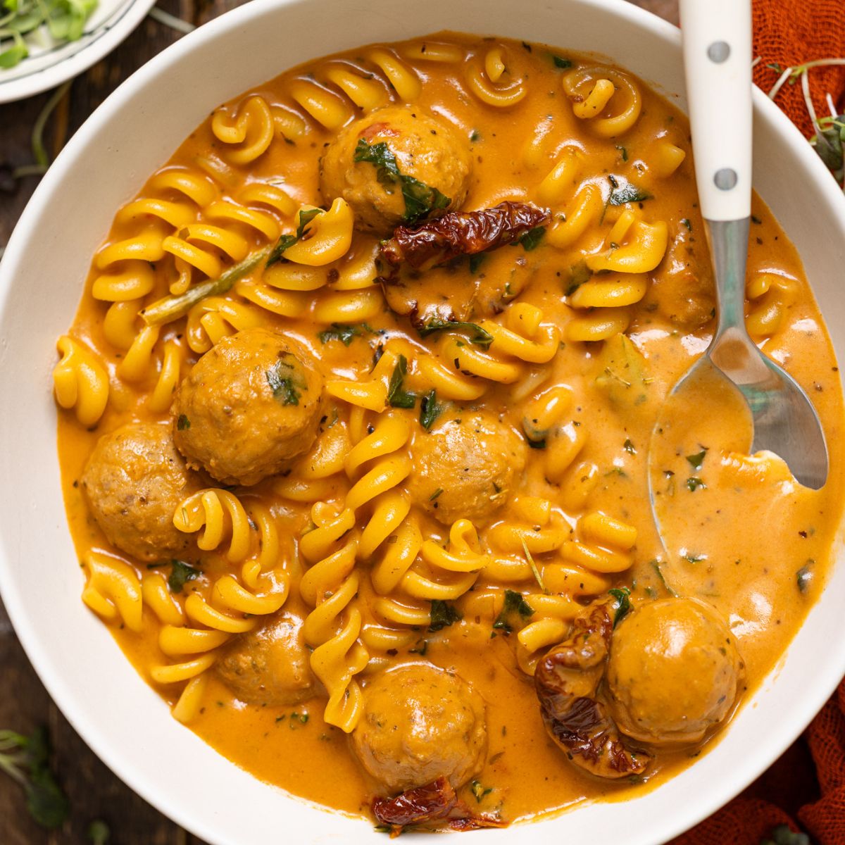Up close shot of Hearty Tuscan 'Marry Me' Meatball Soup with spoons.