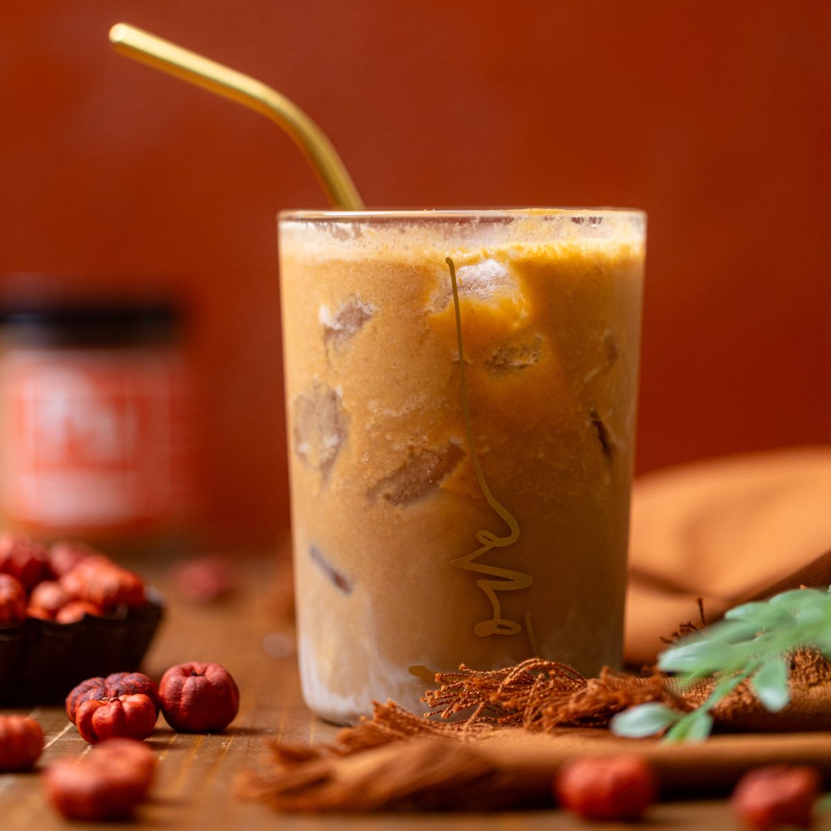 My Fave Pumpkin Dirty Chai Iced Latte in a glass with a straw.