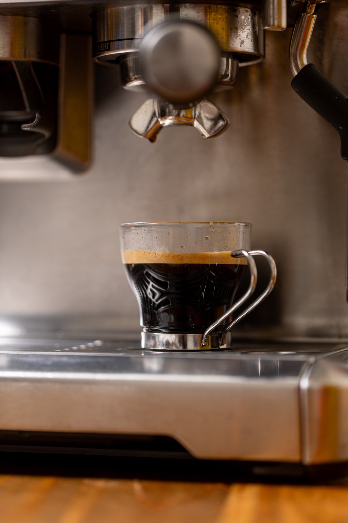 Freshly brewed coffee in an espresso machine.